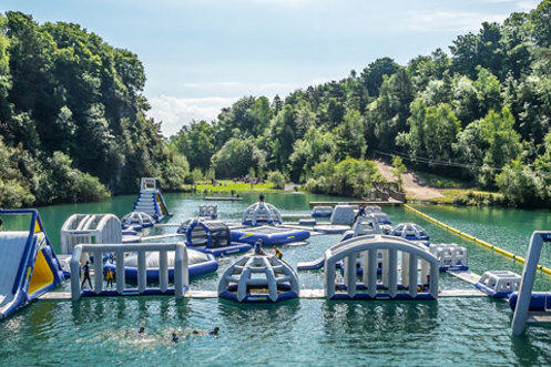 A floating water obstacle park on a body of water set among woodland