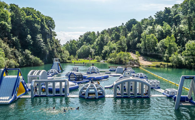 A floating water obstacle park on a body of water set among woodland
