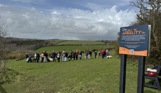 A group of people with dogs in a dog agility field for a Trufts Dog Show at Tregoad Holiday Park