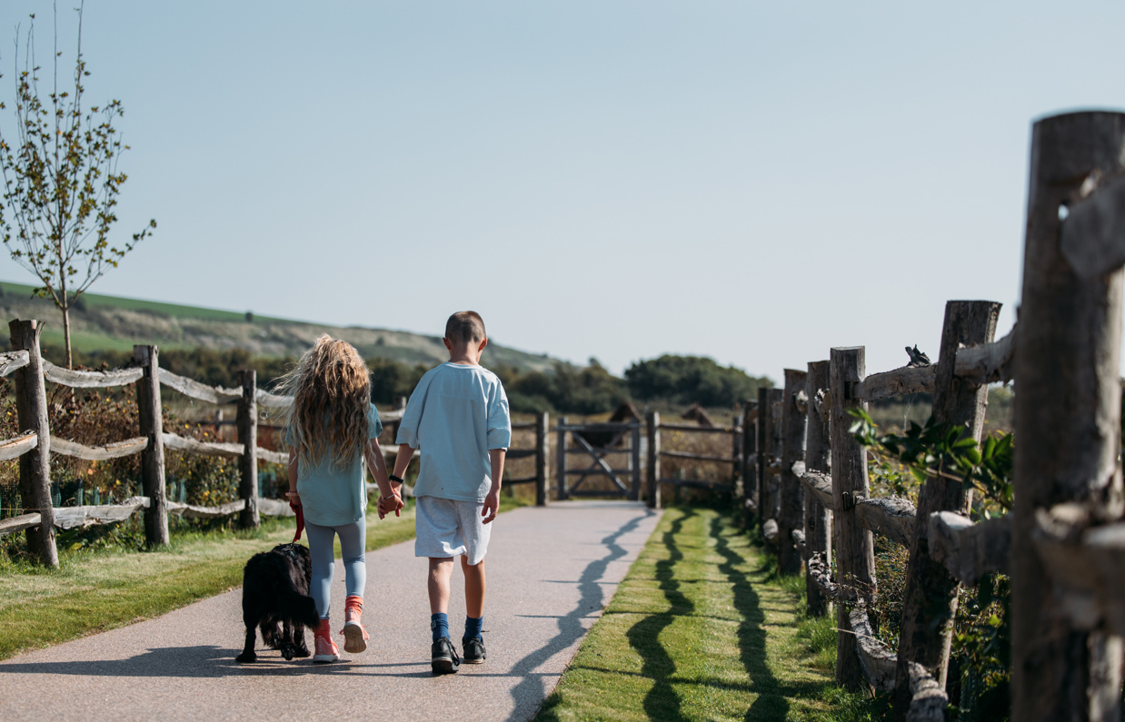 Kids walking their dog in the countryside