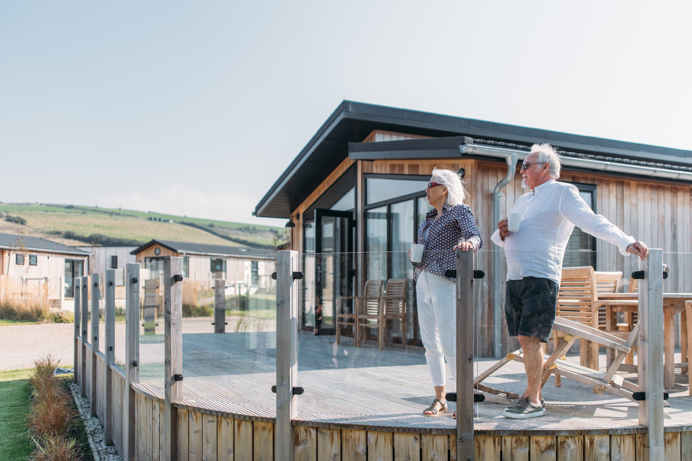 Older couple on lodge decking at The Stables