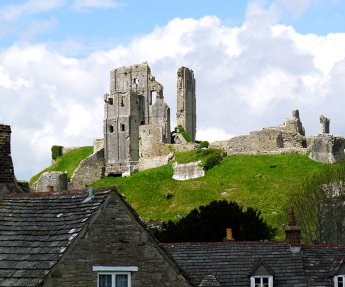 Ruins of a castle atop a hill in a small village