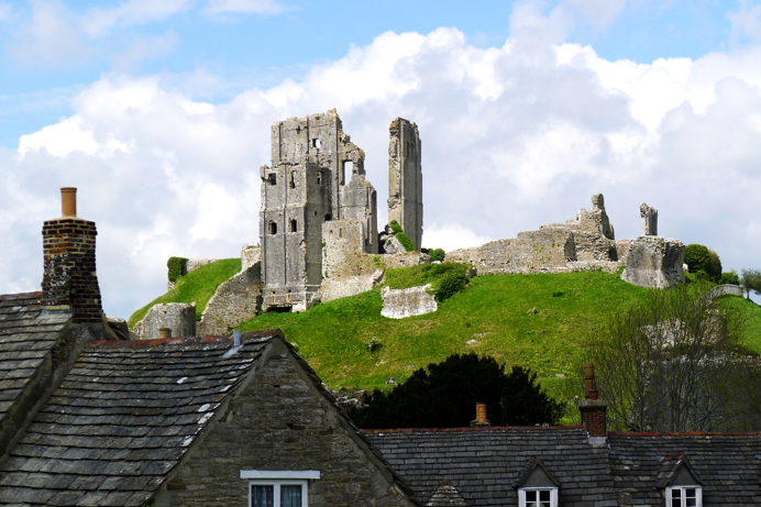 Ruins of a castle atop a hill in a small village