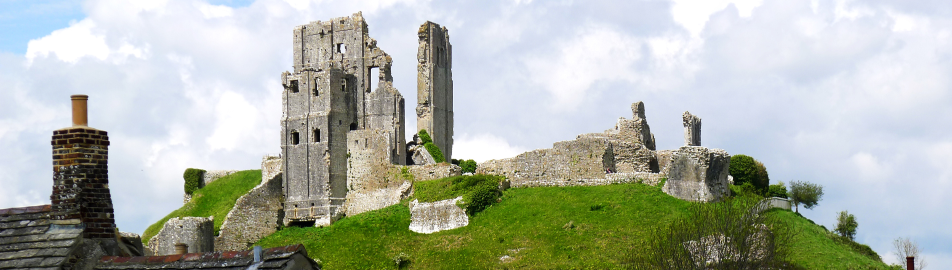 Ruins of a castle atop a hill in a small village