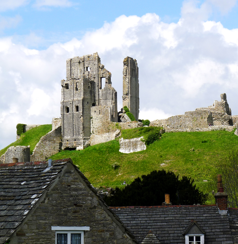 Ruins of a castle atop a hill in a small village