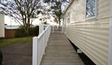 External of an accessible caravan ramp to entrance with decking