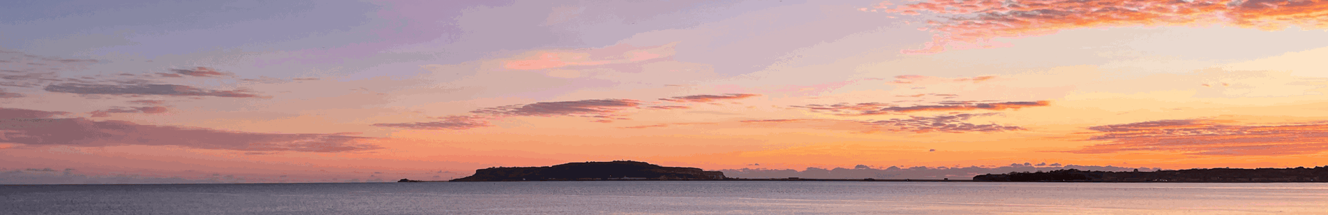 View across to Portland from Bowleaze Cove Holiday Park and Spa at Sunset