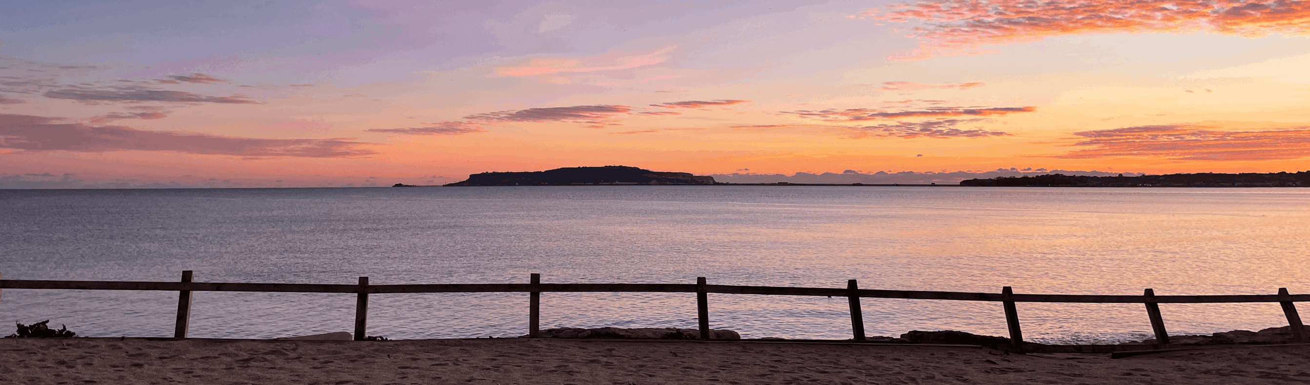 View across to Portland from Bowleaze Cove Holiday Park and Spa at Sunset