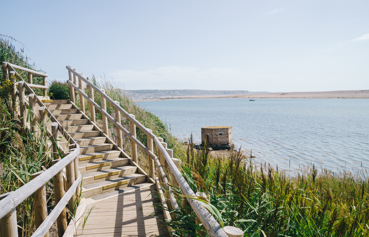 View of the Jurassic Coast, Chesil Beach and sea from the coast path