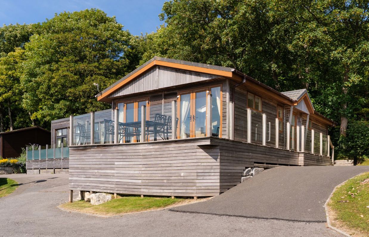 External of a lodge on pitch with decking and driveway space