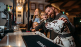 Family at bar with dalmation dog