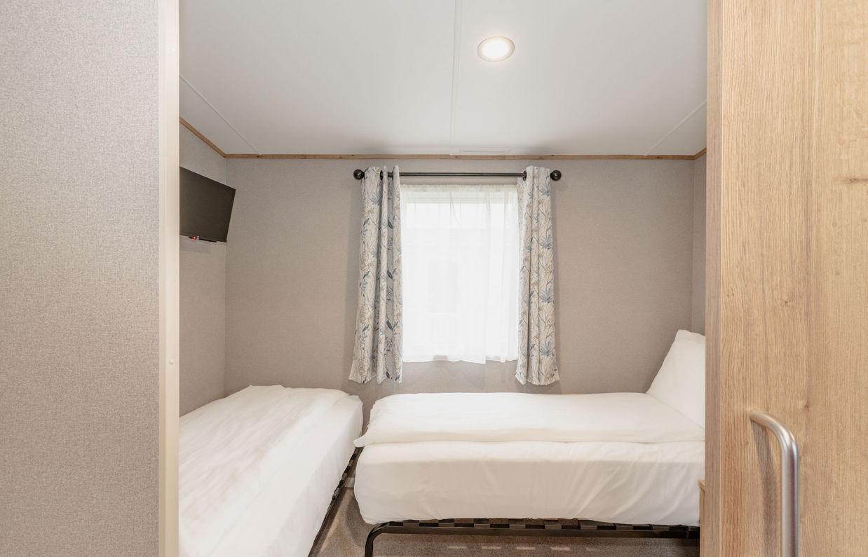 Internal of an accessible caravan spacious twin bedroom 