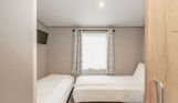 Internal of an accessible caravan spacious twin bedroom 