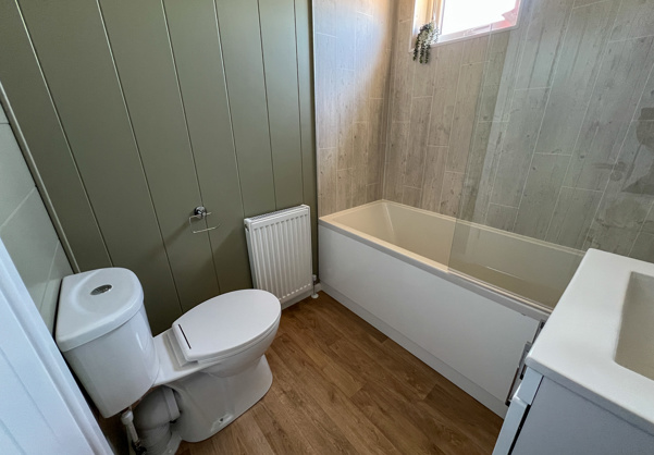 Internal of a luxury lodge bathroom with shower over bath toilet and sink