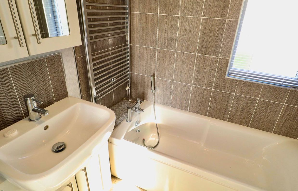 Internal of a caravan bathroom with bath and sink