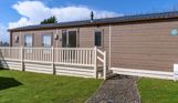 External of a caravan on pitch with decking and a pathway