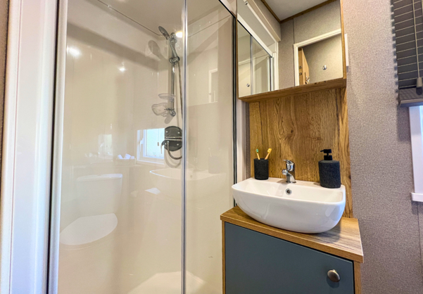 Internal of a caravan bathroom with shower and sink