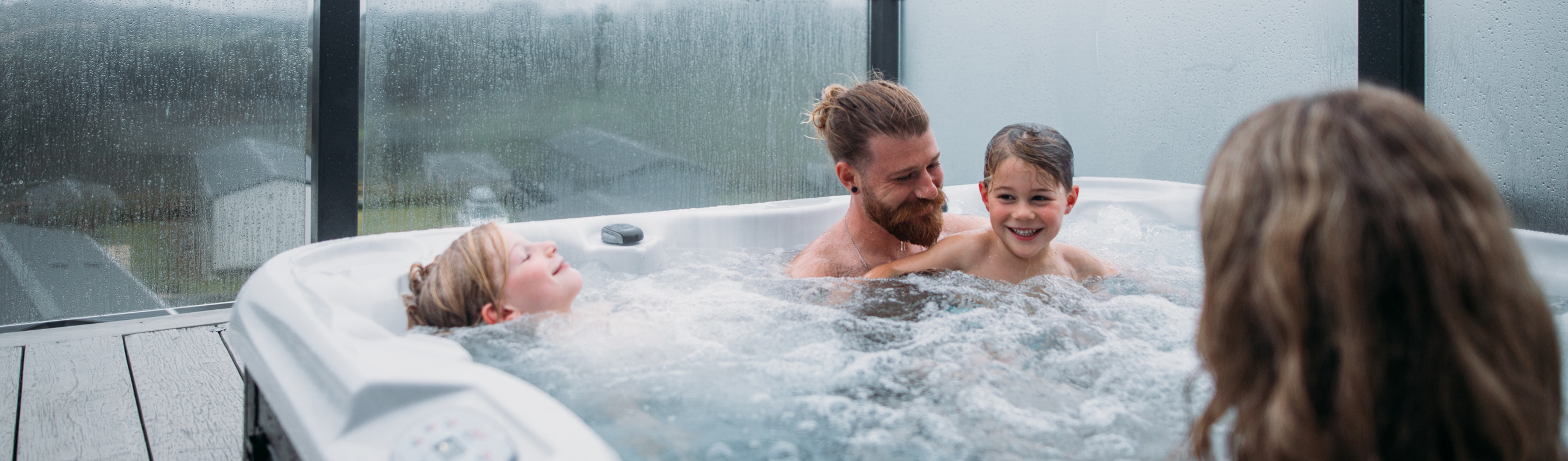Dad playing with kids in hot tub