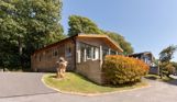 External of a lodge on pitch with decking and driveway space