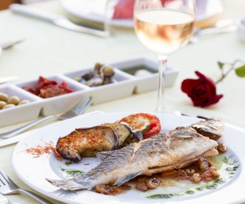 A plate of seafood with wine and nibbles