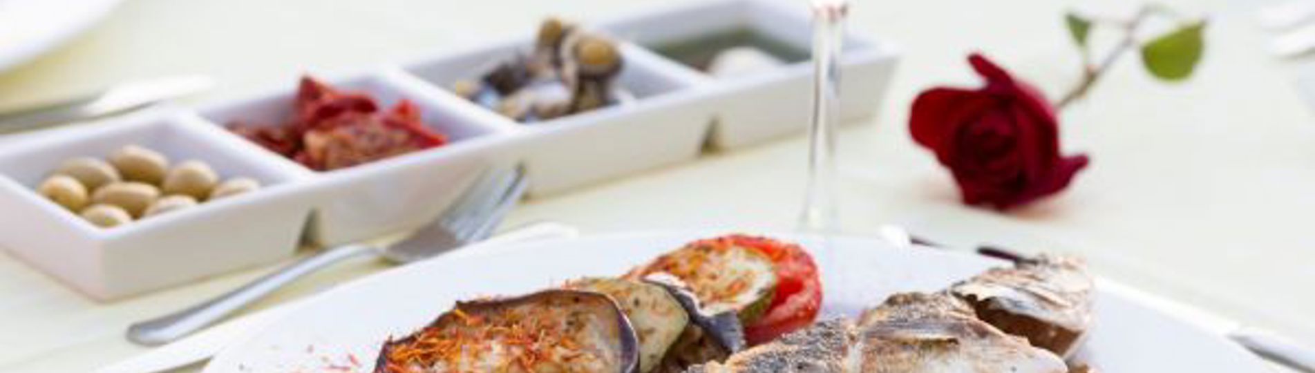 A plate of seafood with wine and nibbles