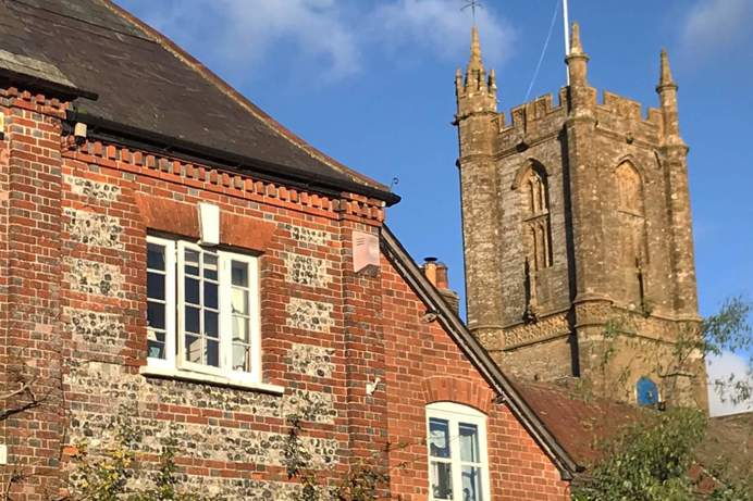 A church building and an adjacent building in a village