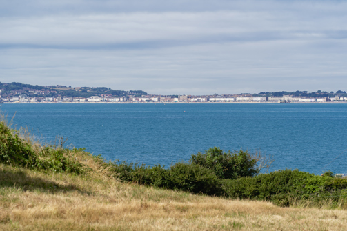 The view of the sea and Weymouth through countryside from Osmington Mills Lodge Park