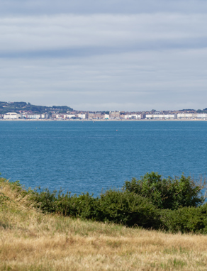 The view of the sea and Weymouth through countryside from Osmington Mills Lodge Park