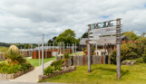 A wooden sign of the 'Treside' area with stargazy, games room, arcade and fire pits at Tregoad Holiday Park