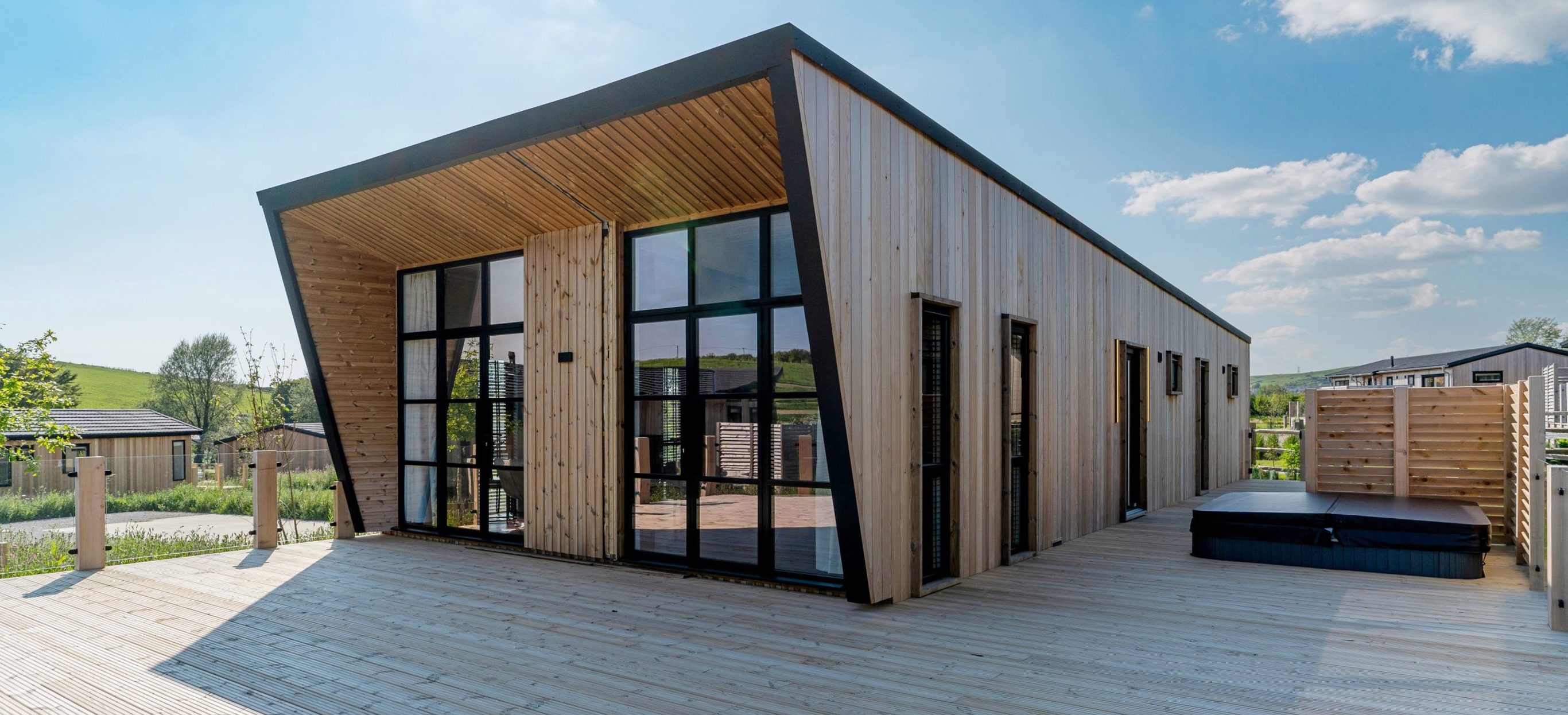 Exterior of a Super Lodge and Large Decking with Hot Tub