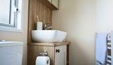 Internal of a caravan bathroom with toilet and sink