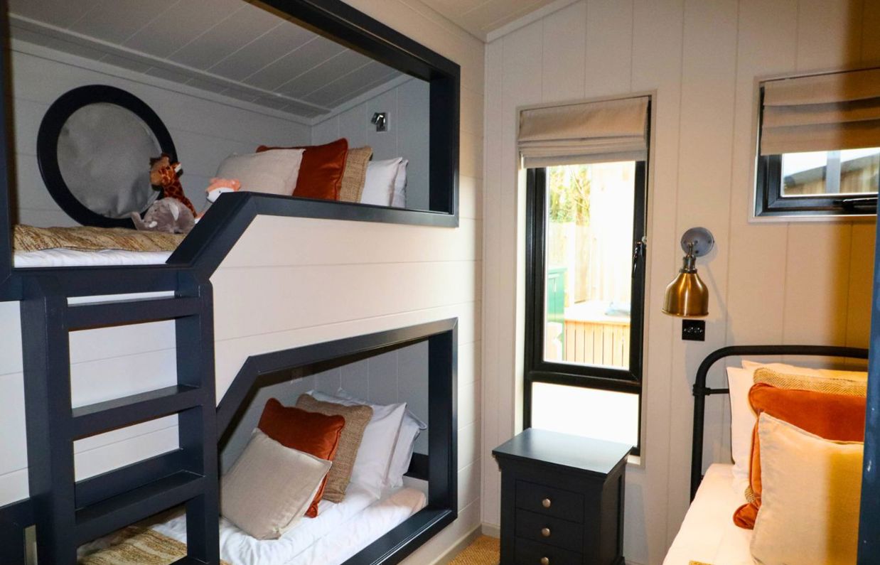Internal of a luxury lodge bunk bedroom with additional single bed