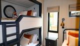 Internal of a luxury lodge bunk bedroom with additional single bed