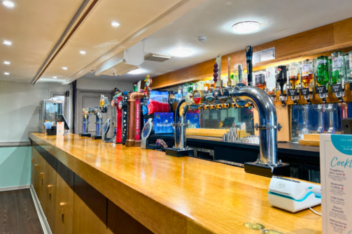 A bar with a range of drinks on draught and bottles available