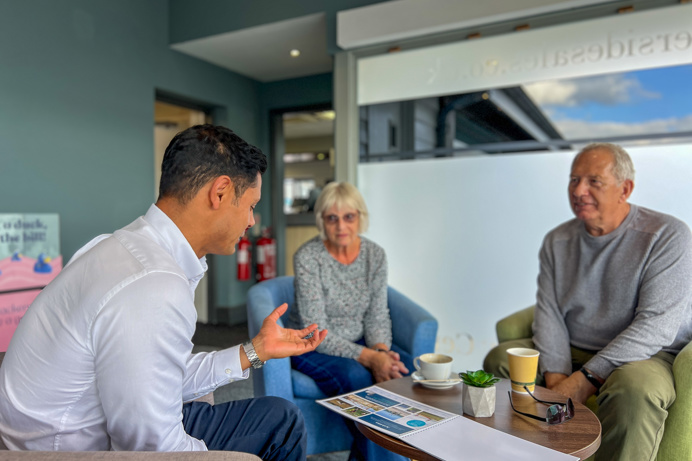 Couple talking with Sales Team Member on an Experience Day