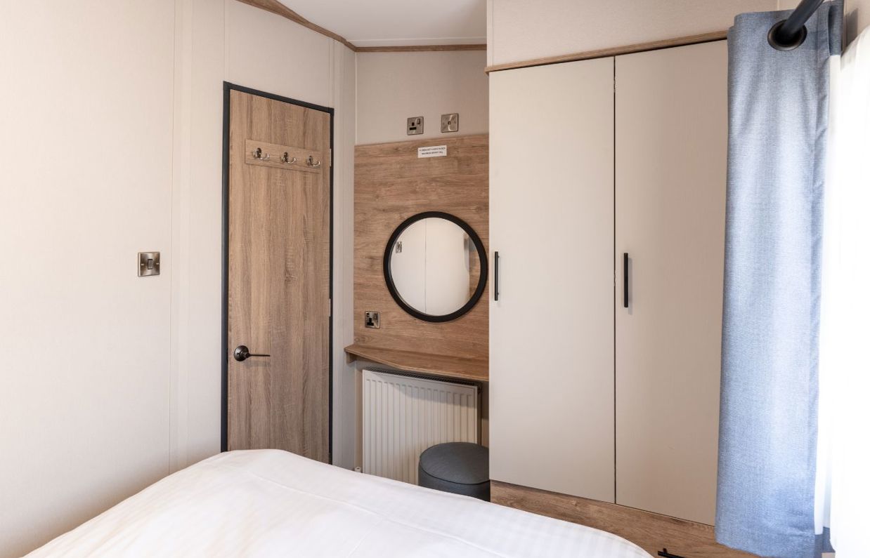 Internal of a caravan master bedroom storage and dressing area