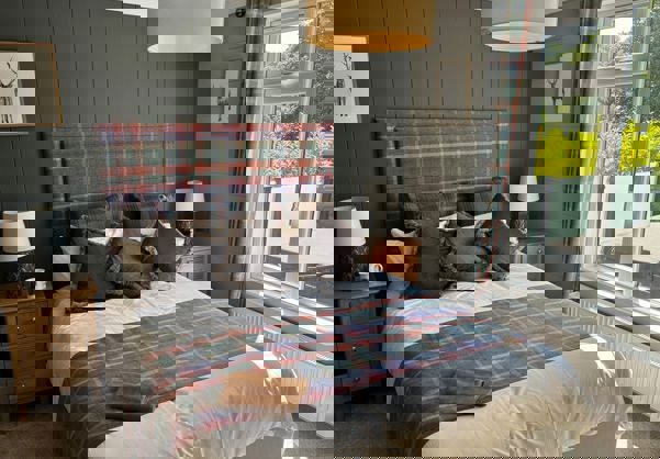 Modern country theme master bedroom with sage walls and checked bedding