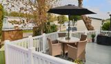 External of a caravan on pitch with decking and outdoor furniture