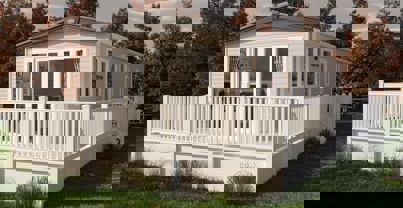 Cladded exterior of holiday home with wrap-around decking