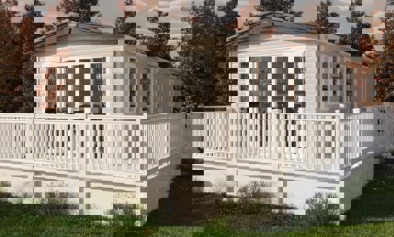 Cladded exterior of holiday home with wrap-around decking