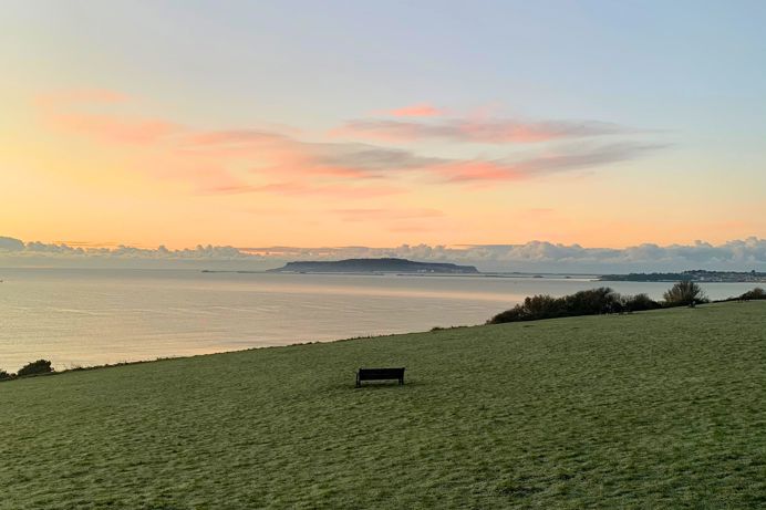 The view out towards Weymouth Bay and Portland from The Lookout Café at sunrise