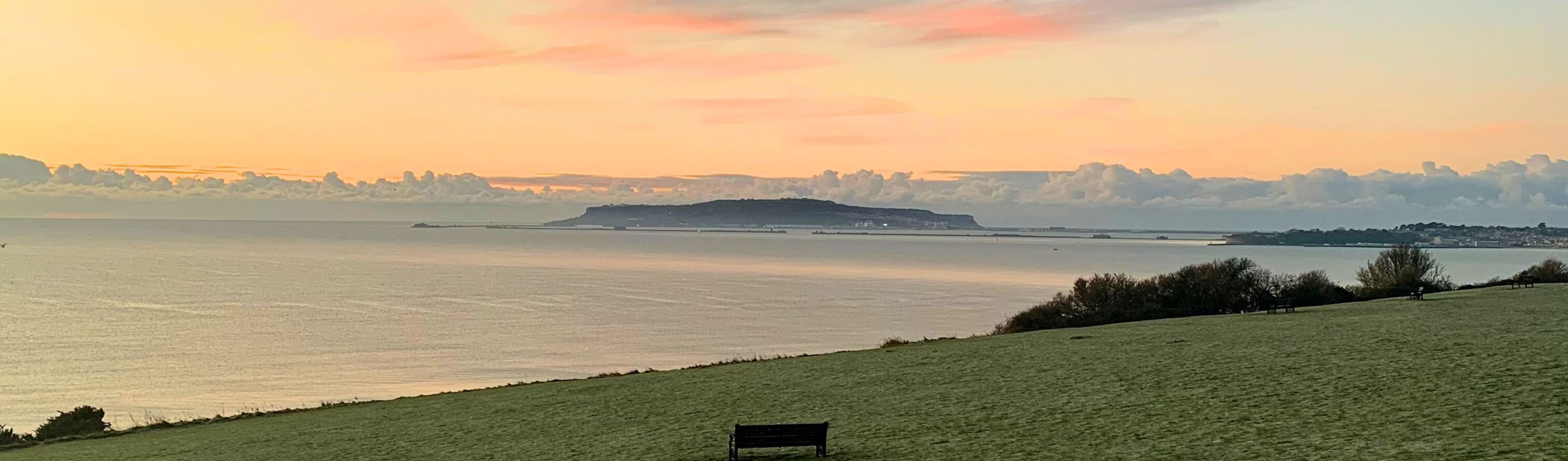 The view out towards Weymouth Bay and Portland from The Lookout Café at sunrise