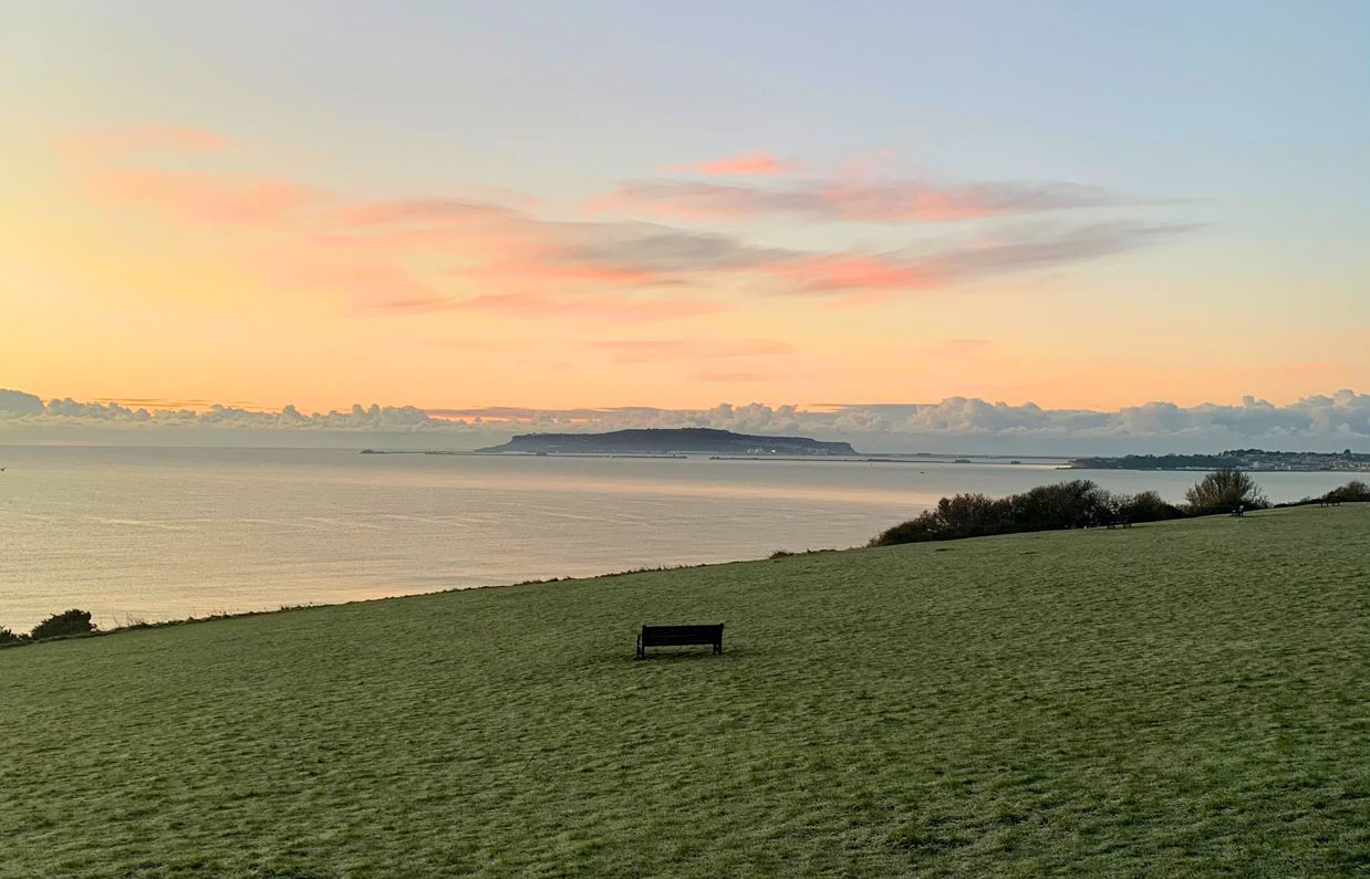 The view out towards Weymouth Bay and Portland from The Lookout Café at sunrise