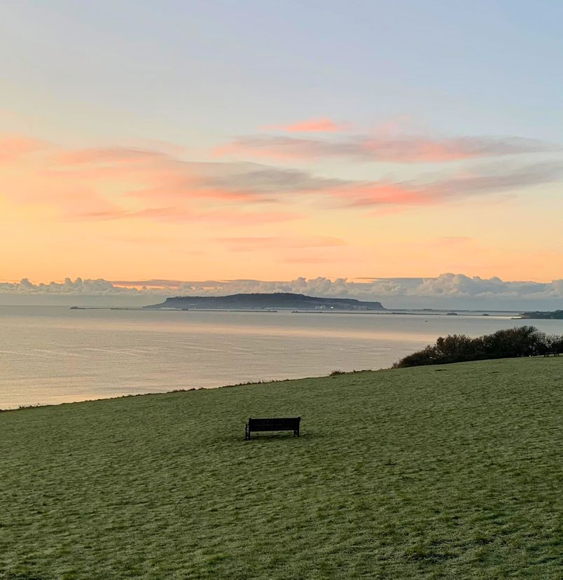 The view out towards Weymouth Bay and Portland from The Lookout Café at sunrise