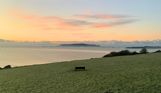 The view out towards Weymouth Bay and Portland from The Lookout Café at sunrise