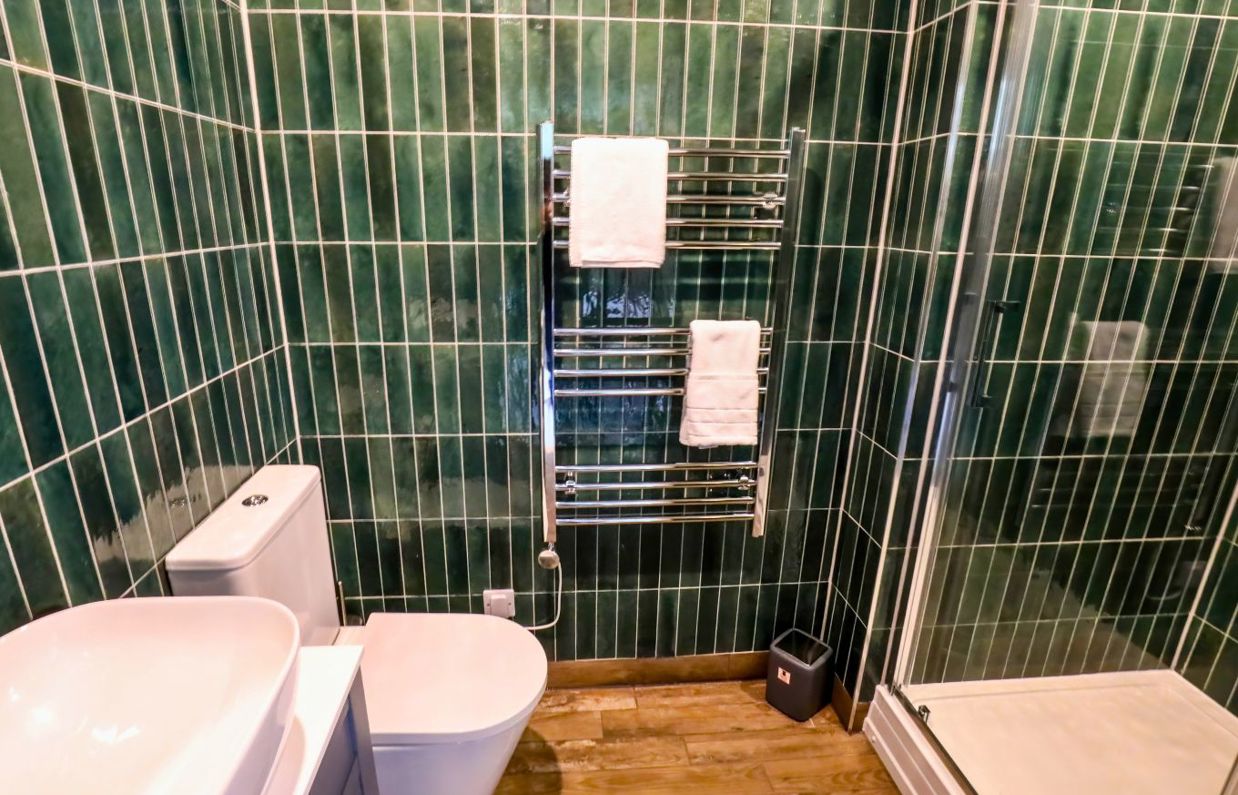 Internal of a manor house bathroom with shower, toilet and sink
