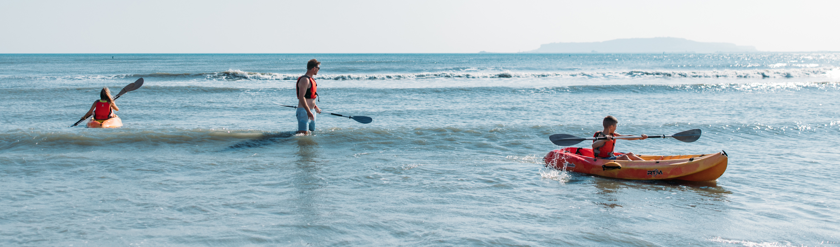 Family kayaking in bowleaze cove