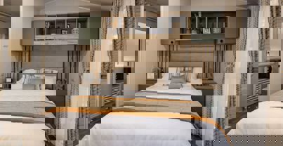 Master bedroom with sage built-in shelving and bedside tables unit