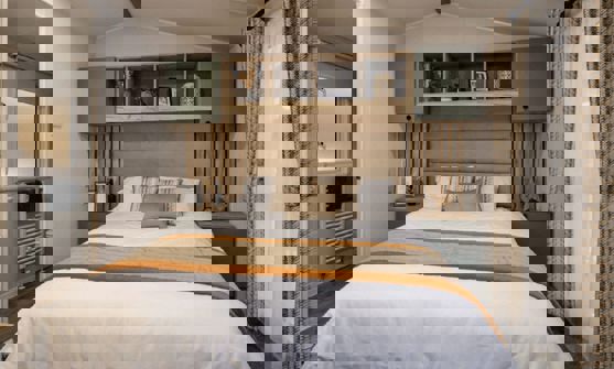 Master bedroom with sage built-in shelving and bedside tables unit