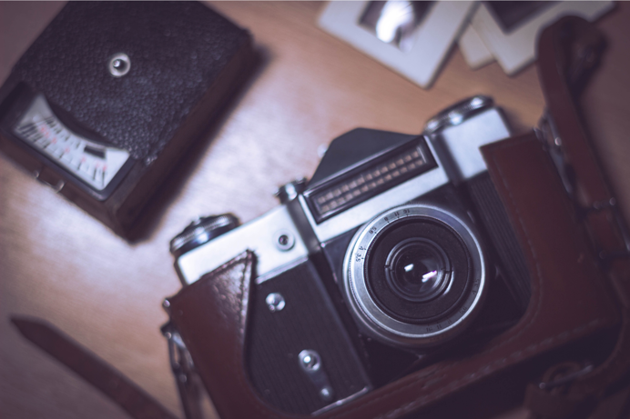 A classic camera and other photography equipment on a table